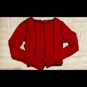 Red long sleeve top.